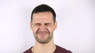 Yakışıklı bir gencin yüzüne ringa balığıyla vurulmasının yavaş çekimi. Genç yakışıklı adamın yüzüne taze balık çarpıyor..