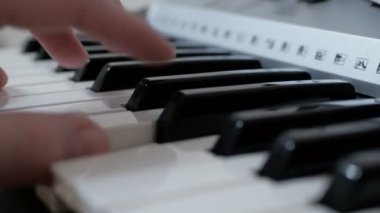 Konser sırasında sentezleyici çalan profesyonel bir müzisyenin ellerinin yakın çekimi..