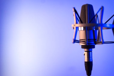 Voiceover and singing large diaphragm microphone in audio and music recording studio on plain background. clipart