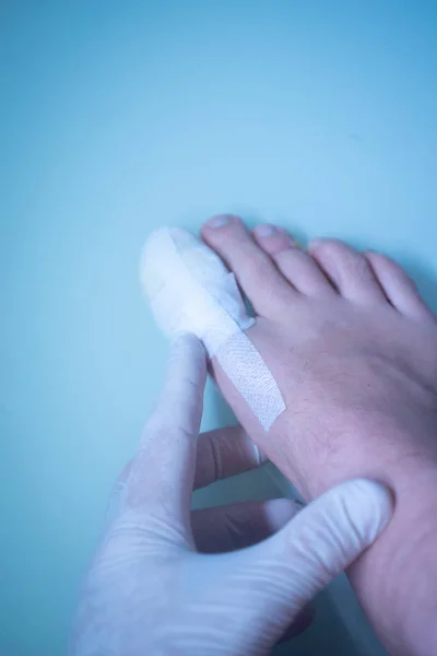 Foot big toe bandage injured feet in medical clinic hospital center.