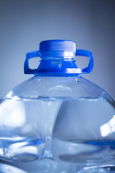 Isolato bottiglia d'acqua di plastica pianura blu sfondo studio colpo — Foto Stock