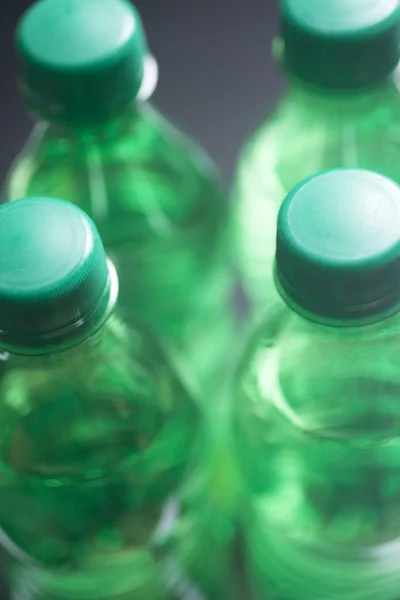 Botellas de agua de plástico aislado estudio de fondo azul —  Fotos de Stock