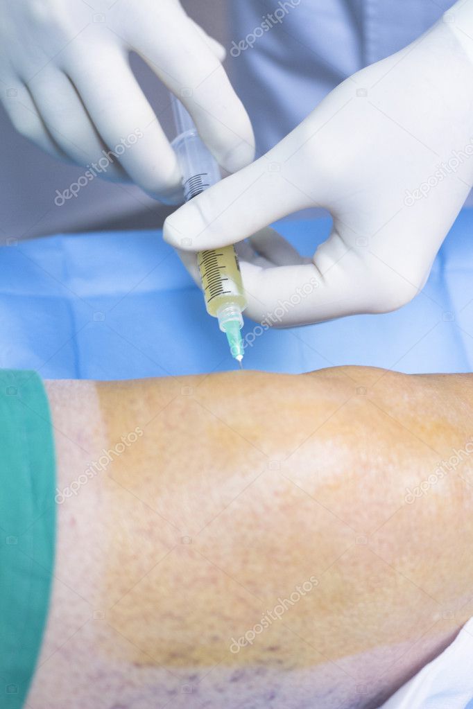 Surgeon doctor injecting PRP in patient in hospital clinic