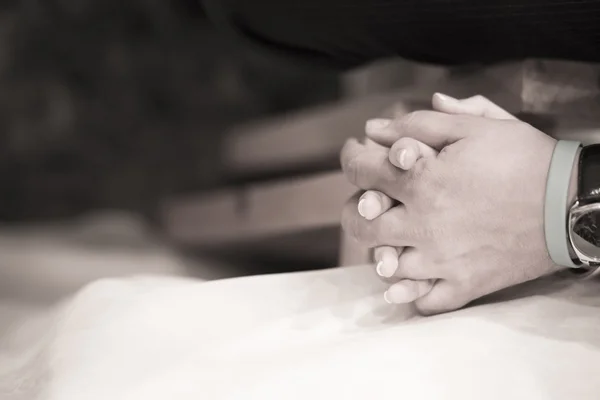 Bride and bridegroom in wedding marriage ceremony holding hands