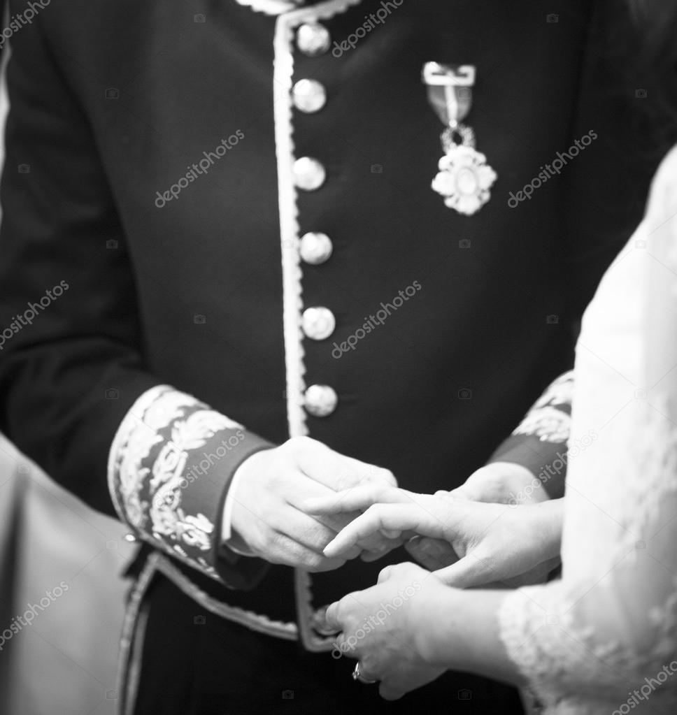 Bride and bridegroom in wedding marriage ceremony holding hands