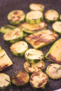 Frying courgettes vegetables herbs saucepan