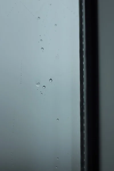 Raindrops on window gray rainy day — Stock Photo, Image