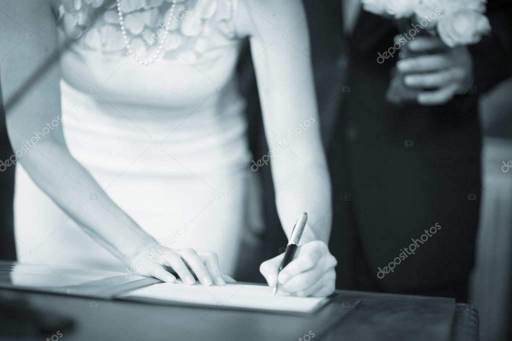 Wedding bride signing marriage register