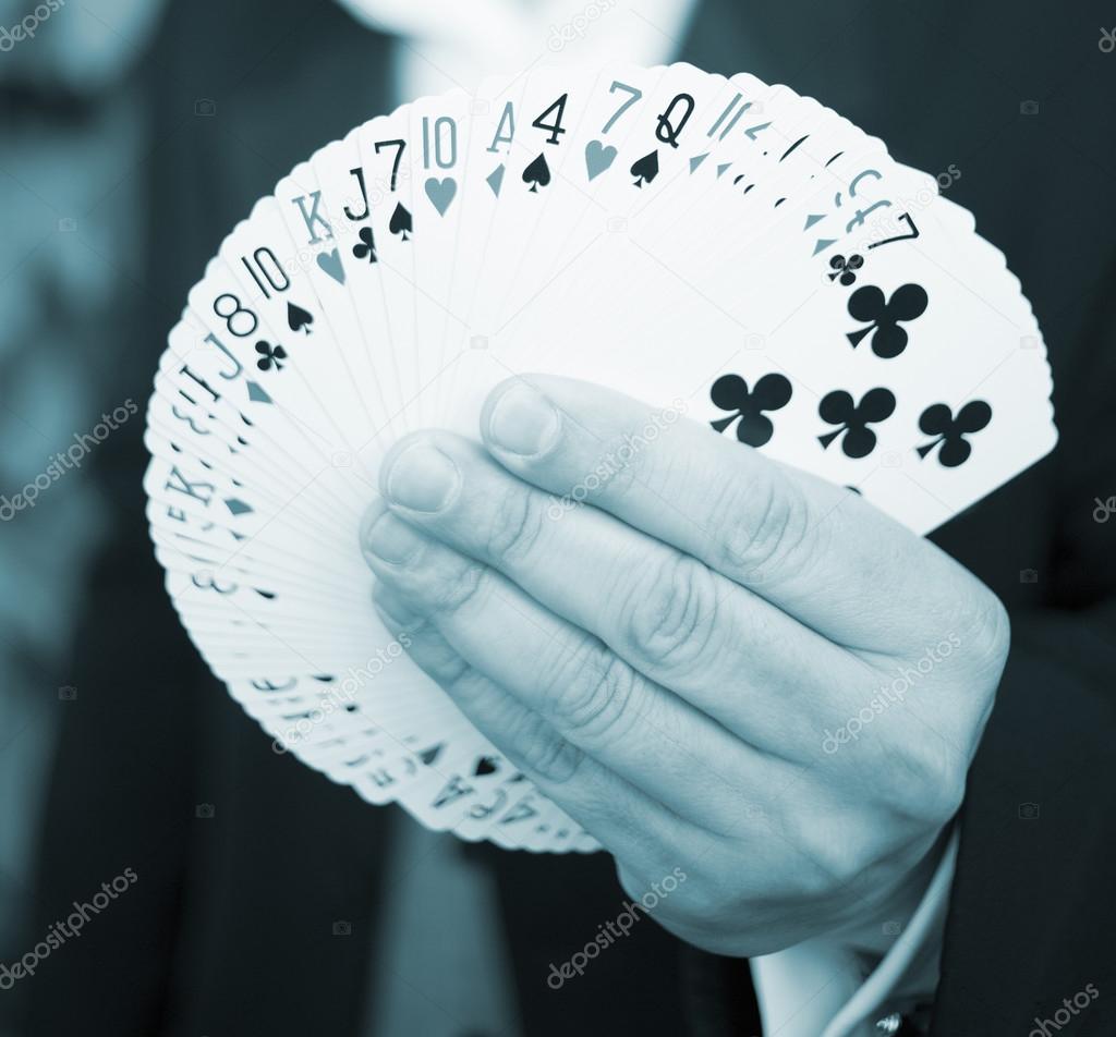 Playing cards in hand of magician