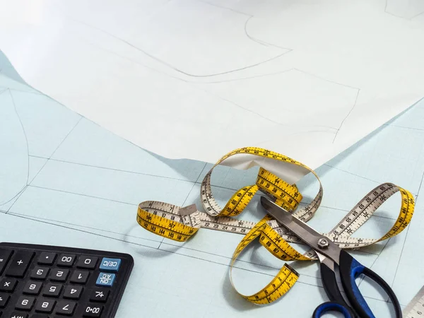 Tailor's measure tape and scissors on paper pattern layout of dress at home — Stock Image Tailor Measure Tape Scissors Paper Pattern Layout Dress Home Royalty Free Stock Images