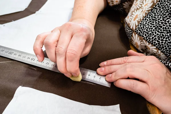 Female hand draws pattern of dress on brown fabric by soap close up at home — Stock Image Female Hand Draws Pattern Dress Brown Fabric Soap Close Home Stock Image