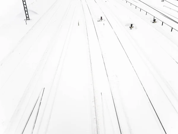 above view of snow-covered railways at station after snowfall on winter day