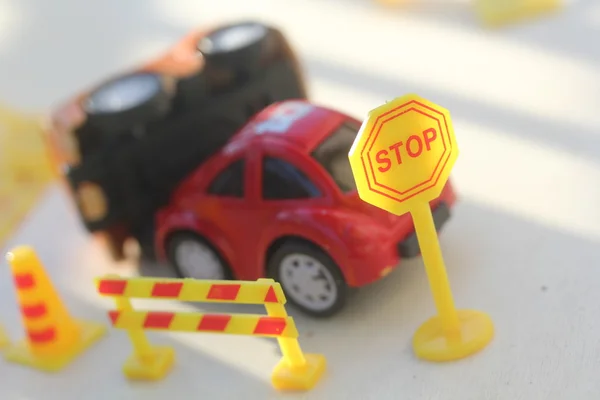 Car Accident zone cordoned off with a yellow stop sign post. two cars with a major collision with one car toppled by another brown car & area cordoned by yellow barricades — Stock Photo, Image