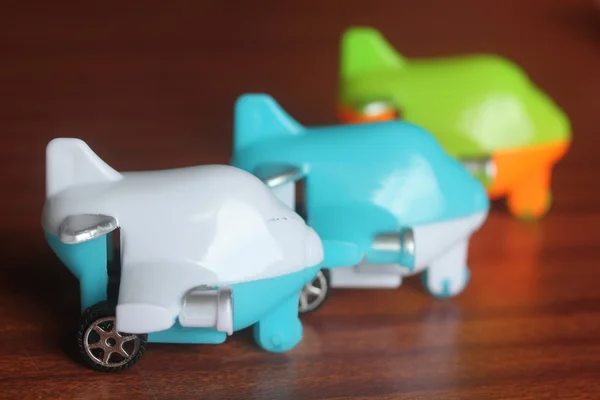 Children toy plane or airplane or aeroplane placed next to each other on a wooden table — Stock Photo, Image