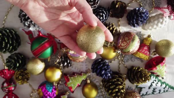 Glass, plastic, Christmas tree decorations on table. Womens hands. Close-up — Stock Video