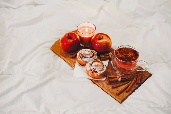 tray at home with autumn drinks and pastries with cinnamon and apples