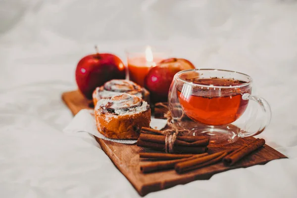 tray at home with autumn drinks and pastries with cinnamon and apples