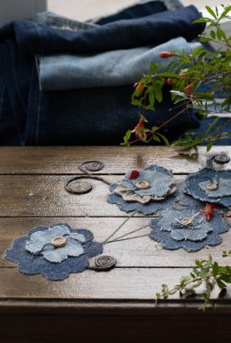 Upcycled old jeans canvas  and pomegranate flowers. Concept of things reuse and natural resources preserving. Multifocused. clipart