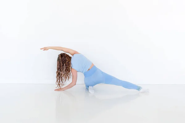 Young Diverse Woman Practices Yoga Doing Body Stretching Exercise Sitting — Stock Photo, Image