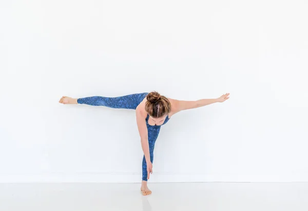 Young Diverse Woman Practices Yoga Pose Standing Floor White Studio — Stock Photo, Image