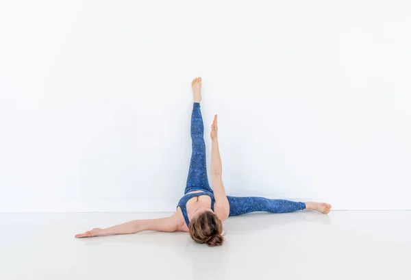 Young Diverse Woman Practices Yoga Pose Standing Floor White Studio — Stock Photo, Image