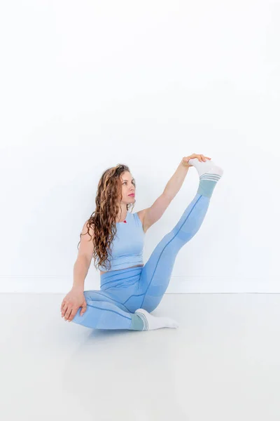 Young Diverse Woman Practices Yoga Doing Body Stretching Exercise Sitting — Stock Photo, Image