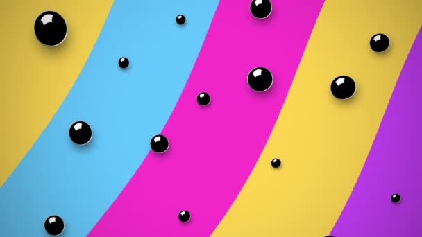 Zwarte bollen op multi gekleurde achtergrond in 4k video. — Stockvideo
