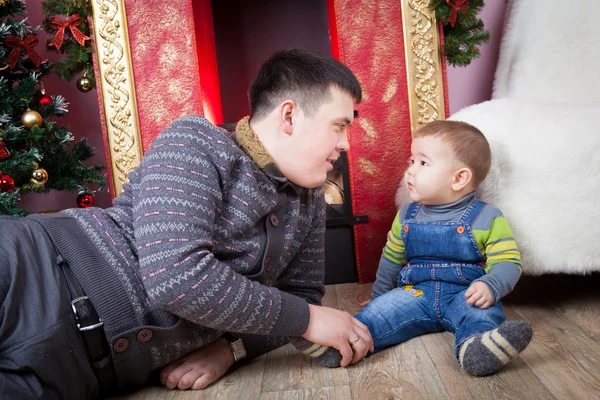 Vader met zijn zoon in de buurt van de kerstboom — Stockfoto