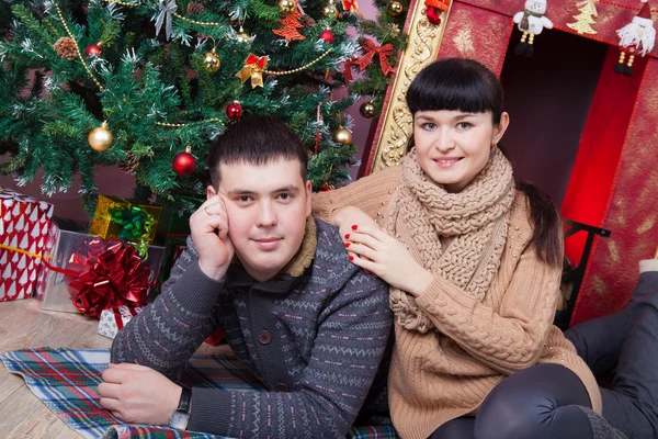 Couple near a Christmas tree — Stock Photo, Image