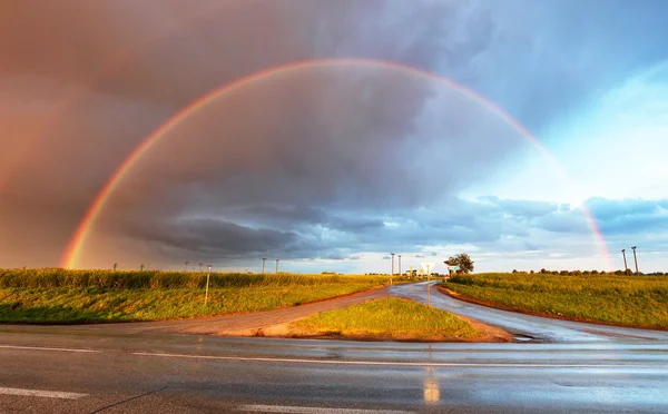 Rainbow over road — Stock Photo, Image