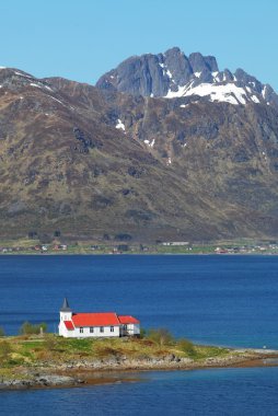 Church in fjord on Lofoten islands clipart