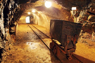 Underground train in mine, carts in gold, silver and copper mine clipart