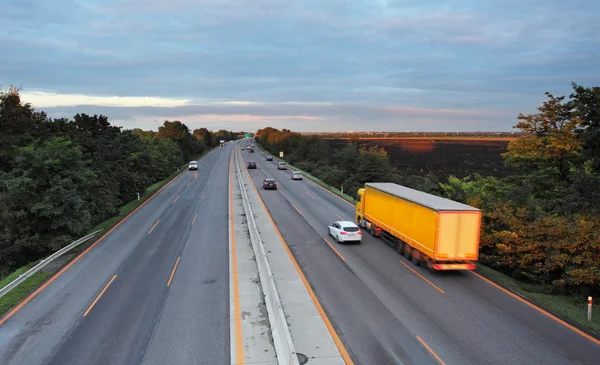 Autostrada z samochody i ciężarówki — Zdjęcie stockowe