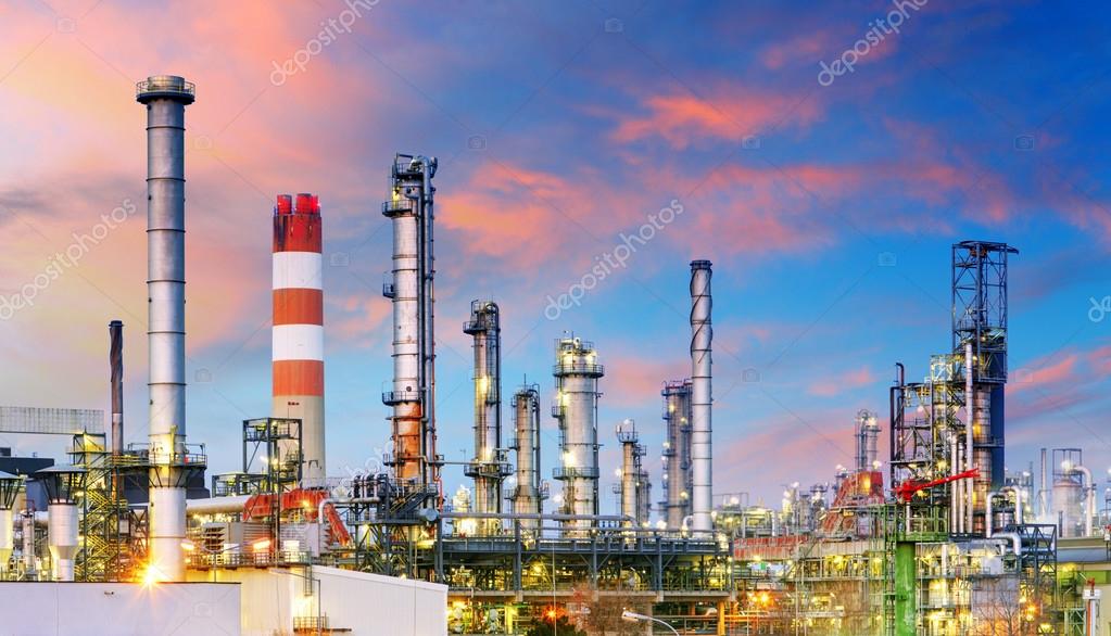 Petrochemical plant at night, oil and gas industrial Stock Photo by
