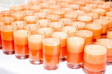 Açık büfe masasında farklı içkiler olan bir sürü bardak.