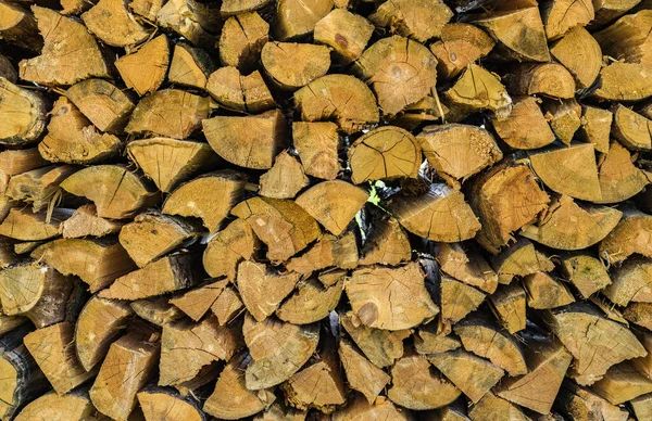 Pile of chopped wood for fireplace, background texture