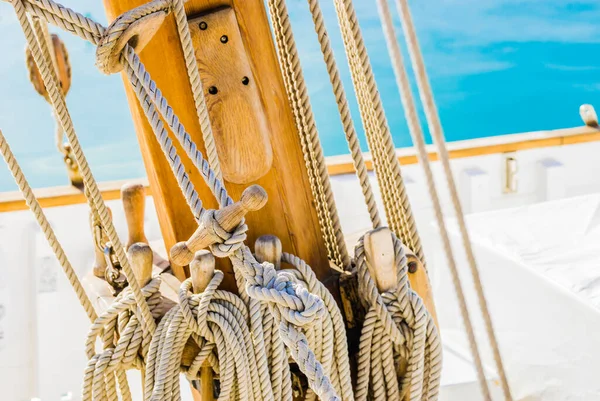 Detail view of old sailing yacht rigging on wooden mast