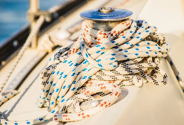 Close-up of winch with nautical rope on boat deck of sailing boat