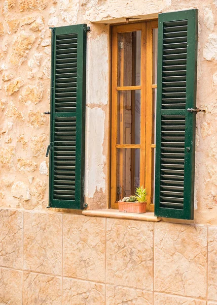 Detail view of open wooden green window shutters