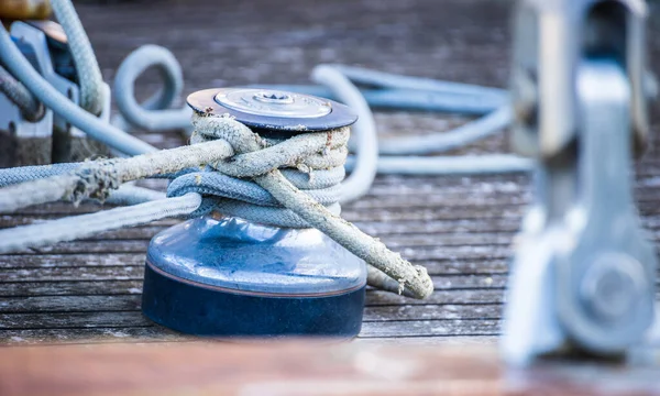 Winch and rope, sailing yacht detail view on boat deck on sailing yacht
