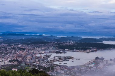 Sasebo şehri geceleri Japonya 'nın Nagasaki kentindeki Yumihari Dağı' ndan gökyüzüne yükselir.