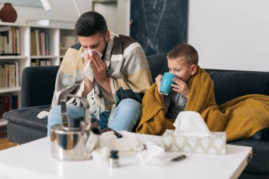 Baba ve oğul üşütürler. Evde hasta oturuyorlar.