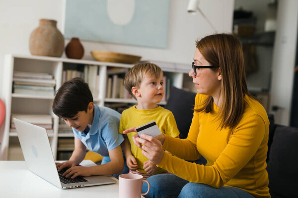 mother and her sons shopping online at home