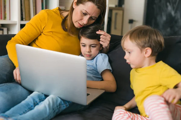 Mãe Com Seus Dois Filhos Usando Computador Portátil Casa — Fotografia de Stock