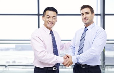 businessmen shaking hands at airport clipart