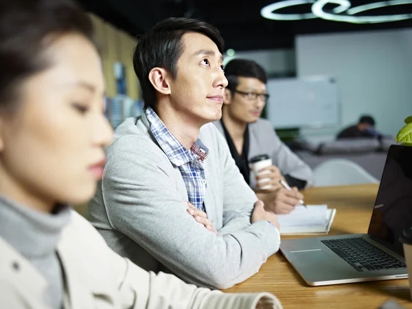 Young asian businessman thinking during meeting — Stock Photo, Image