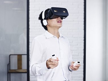 Genç Asyalı adam VR oyun oynuyor