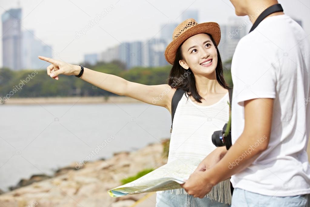 young asian tourists on the road