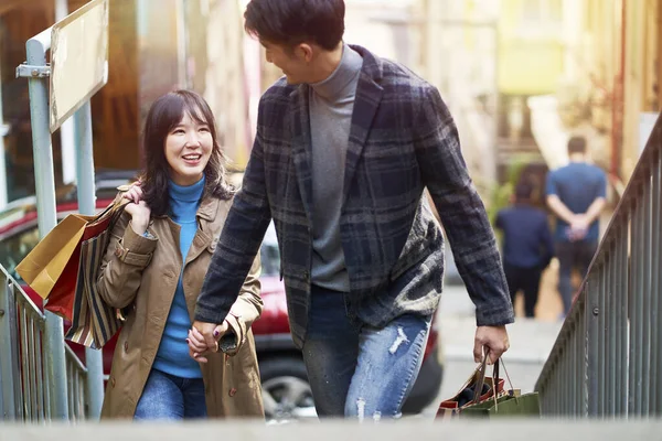 Happy Young Asian Couple Walking Talking Holding Hands While Shopping — Stock Photo, Image