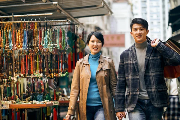 Young Asian Couple Walking Street Commodity Market Carrying Shopping Bags — Stock Photo, Image